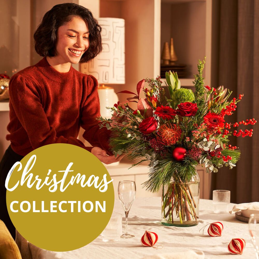 Woman arranging a Christmas bouquet on a Vase